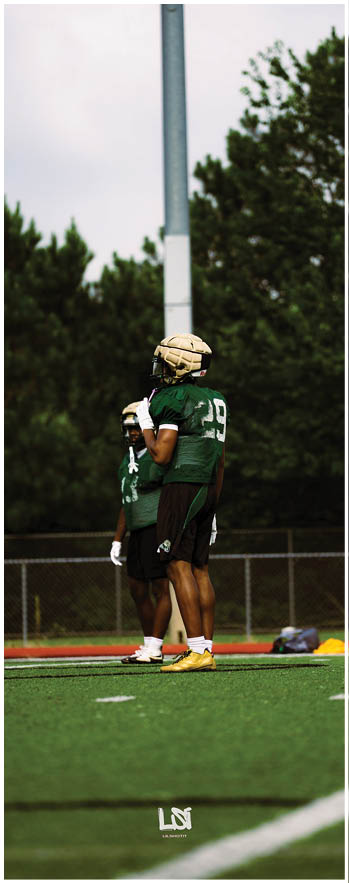 A football player running on the field. Description generated by AI