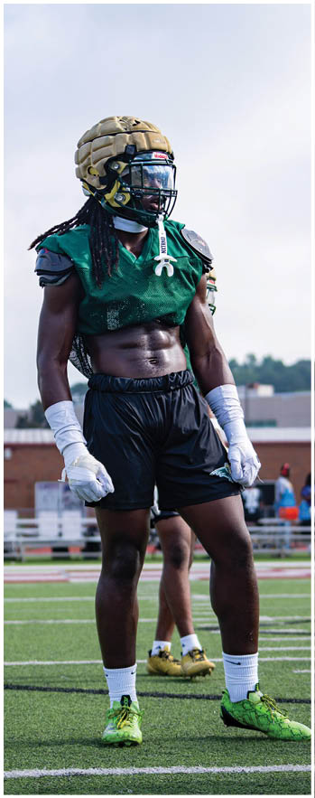 A football player running on the field. Description generated by AI