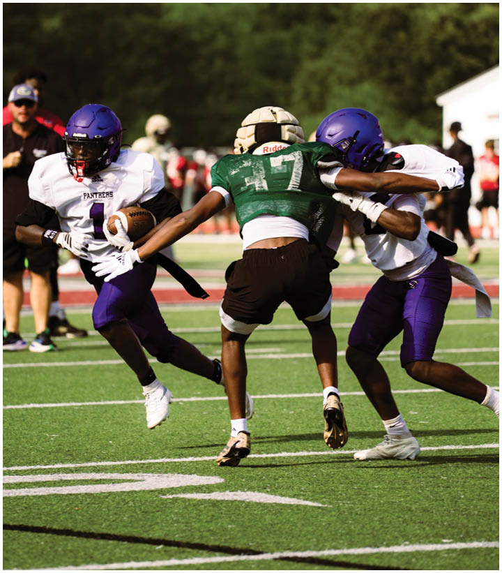 A group of football players wearing black and white uniforms. Description generated by AI