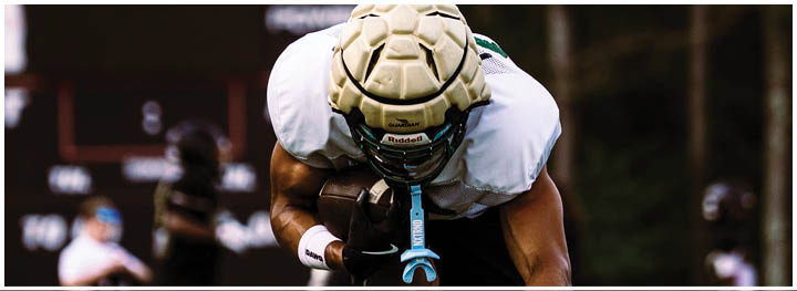 A football player is sliding on the ground. Description generated by AI