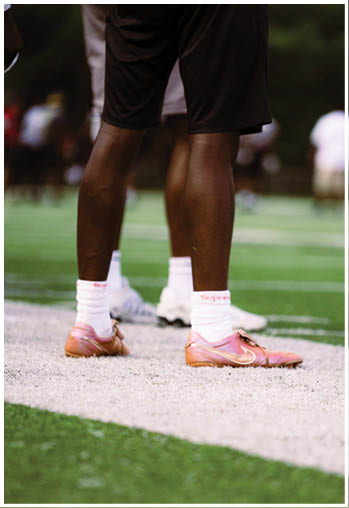 A football player running on the field. Description generated by AI