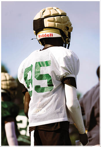 A football player running on the field. Description generated by AI