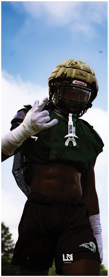 A football player running on the field. Description generated by AI