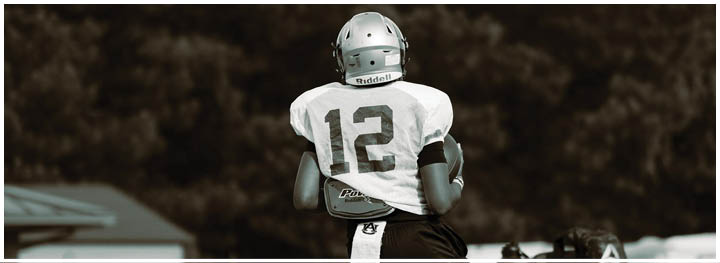 A football player is sliding on the ground. Description generated by AI