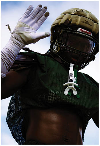 A football player running on the field. Description generated by AI
