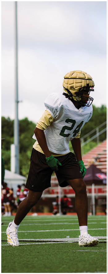 A football player running on the field. Description generated by AI