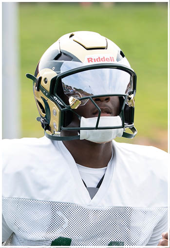 A football player running on the field. Description generated by AI