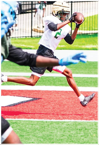 A football player running on the field. Description generated by AI