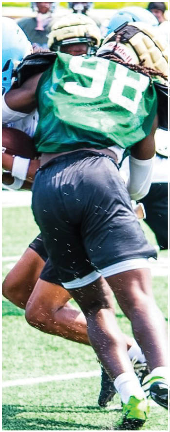 A football player running on the field. Description generated by AI