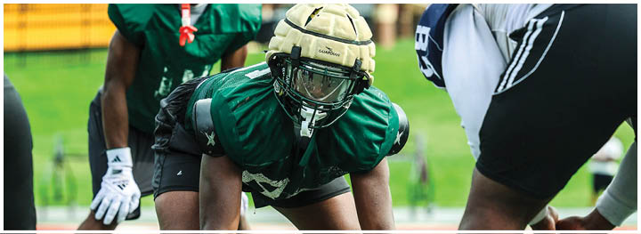 A football player is sliding on the ground. Description generated by AI