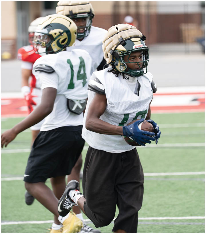 A group of football players wearing black and white uniforms. Description generated by AI