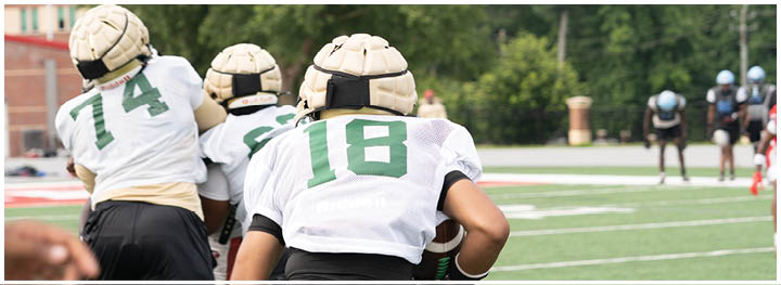 A football player is sliding on the ground. Description generated by AI