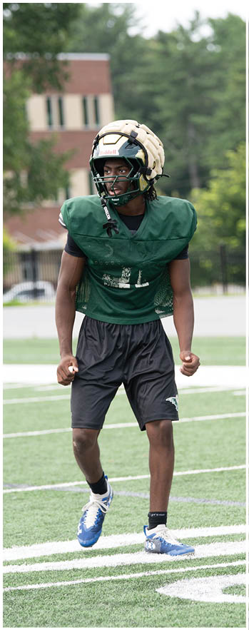 A football player running on the field. Description generated by AI