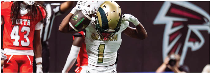 A person in a white and gold football uniform with the number one is celebrating on the field while two people in red uniforms stand nearby. Description generated by AI