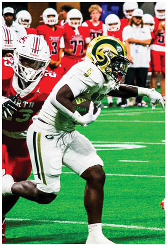 A person in a white and yellow football uniform is running with the ball while two people in red and white uniforms are attempting to catch them on a green field. Description generated by AI