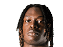 A young man wearing a white jersey with the number 10 on it. Description generated by AI