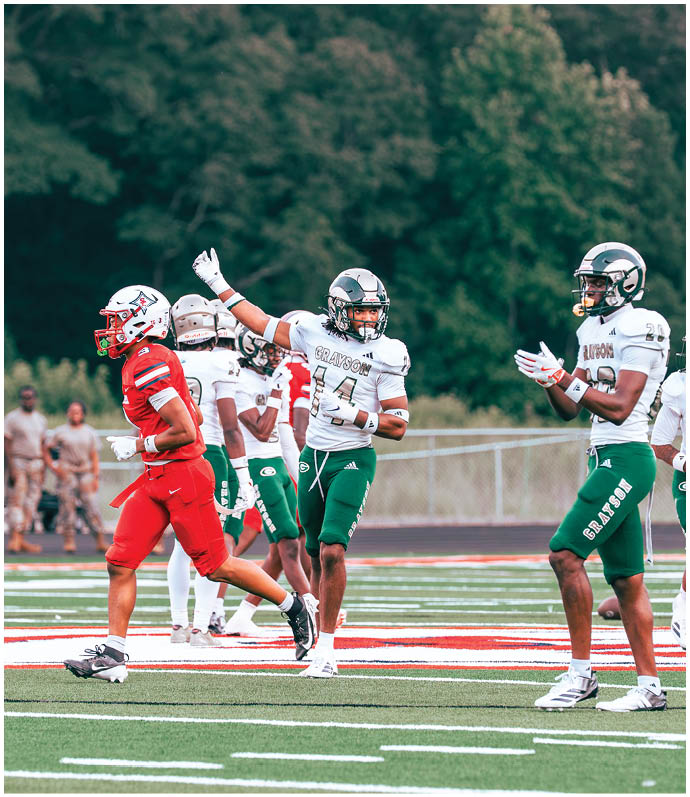 Adults in football uniforms are on a field with one player in red running and others in white and green celebrating or preparing to play. Description generated by AI