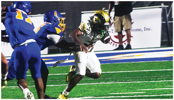 A person wearing a white football uniform and gold helmet is catching a football on a green field during a game. Description generated by AI