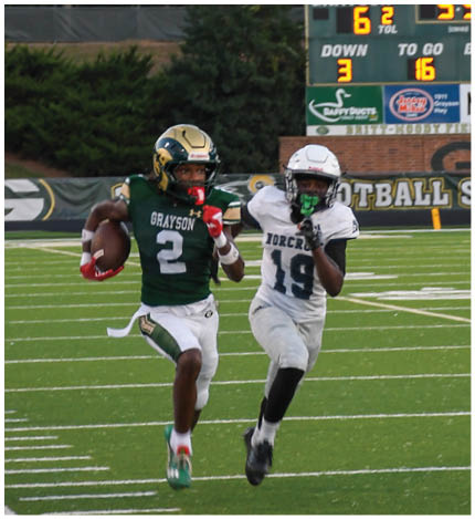 A person wearing a white football uniform with the number 13 is walking on a field toward a group of similarly dressed players standing on the sidelines. Description generated by AI