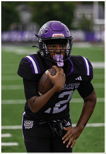 A football player running on the field. Description generated by AI