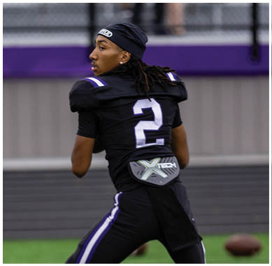 A football player running on the field. Description generated by AI