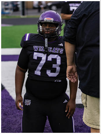 A football player wearing a blue jersey with the number 58 on it. Description generated by AI