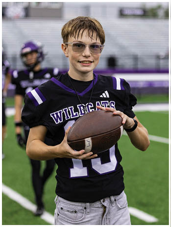 A football player wearing a blue jersey with the number 58 on it. Description generated by AI