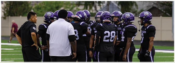 A group of football players on a field. Description generated by AI