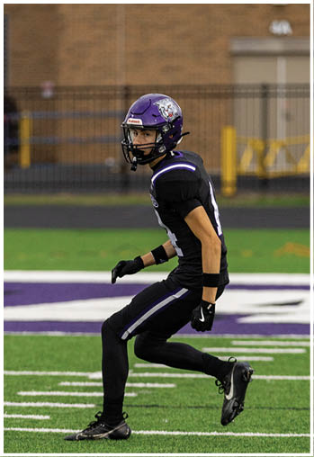 A football player running on the field. Description generated by AI