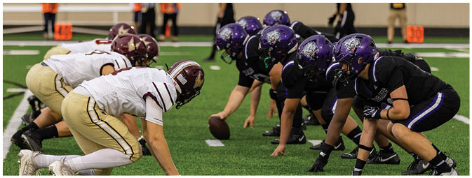 A football player is sliding on the ground. Description generated by AI