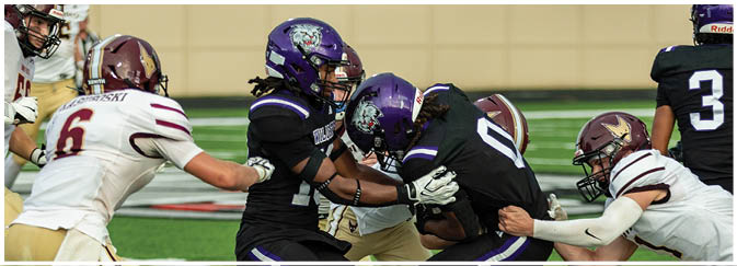 A group of football players on a field. Description generated by AI