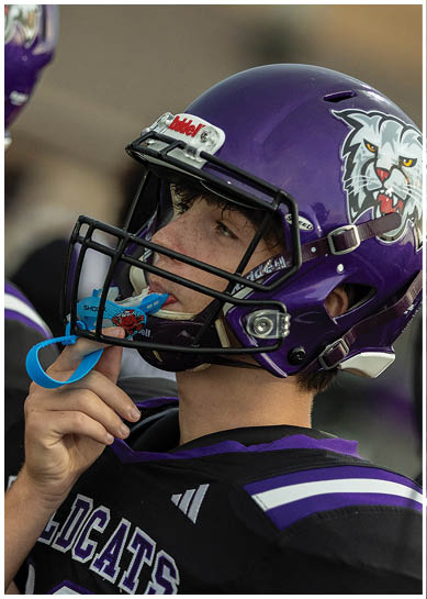 A football player wearing a blue jersey with the number 58 on it. Description generated by AI