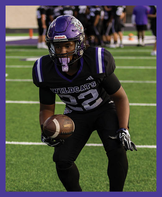 A football player in a white uniform is running with a football in his hand. AI generated content