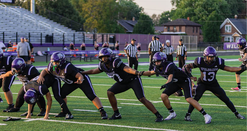 A group of people are kneeling on a field, possibly in a football game. AI generated content