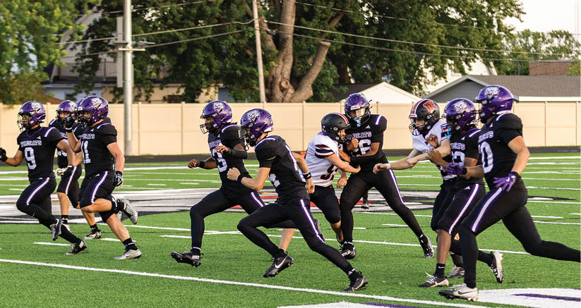 A group of people are kneeling on a field, possibly in a football game. AI generated content