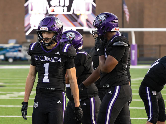 A group of football players in black and white uniforms are on the field. AI generated content