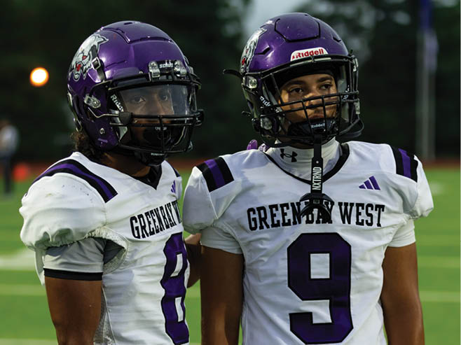 A group of football players in black and white uniforms are on the field. AI generated content