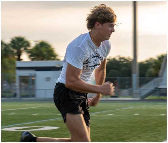 A man running on a field. Description generated by AI