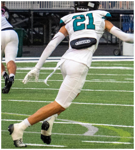 A football player running on the field. Description generated by AI