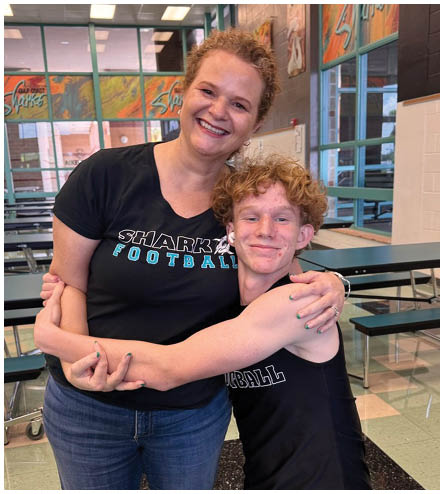 A woman and a boy hugging each other. Description generated by AI
