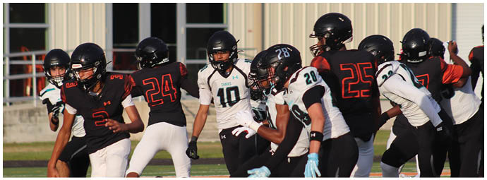 A group of football players on a field. Description generated by AI
