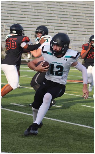 A football player wearing a white jersey with the number 12. Description generated by AI
