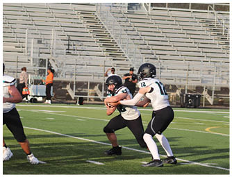 A football game is being played on a field. Description generated by AI