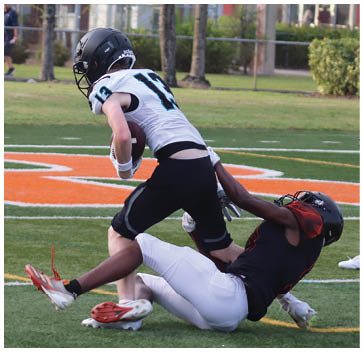 A man is sliding into a base while another man tries to catch the ball. Description generated by AI
