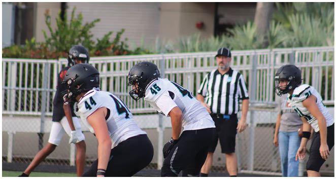A group of football players on the field. Description generated by AI