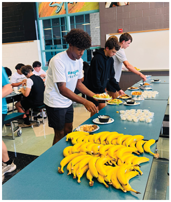 A table with a bunch of bananas on it. Description generated by AI