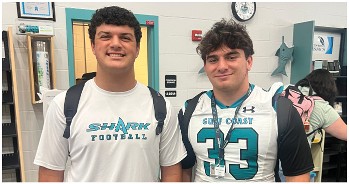 Two men wearing football jerseys. Description generated by AI