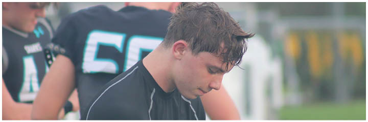 A man wearing a black shirt with the number 50 on it. Description generated by AI