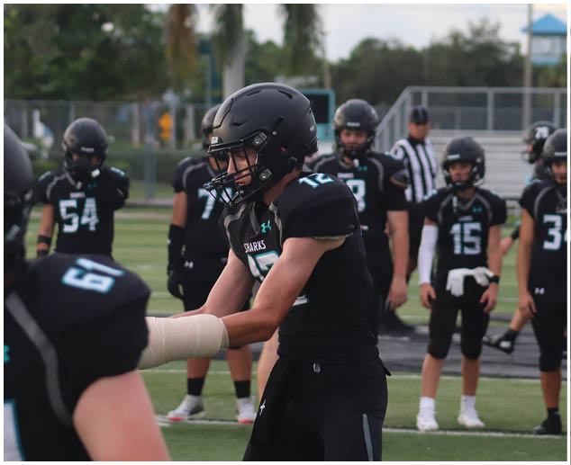 A group of football players wearing black jerseys with the number 17 on them. Description generated by AI