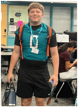 A man wearing a blue and orange jersey. Description generated by AI